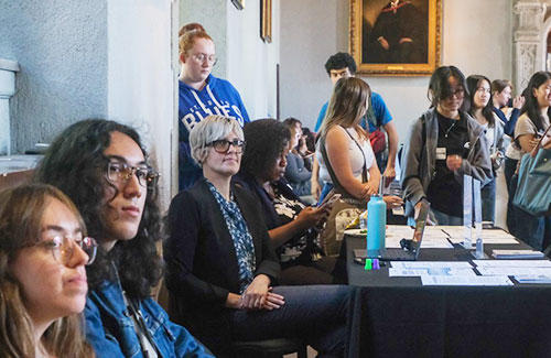 Peoplesitting at a table looking off camera