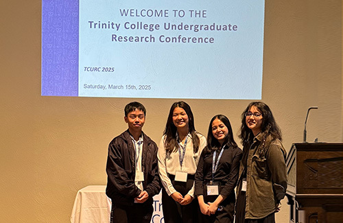 A group of students on stage at a conference