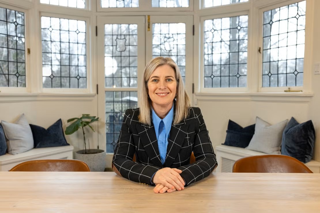 Melanie Woodin sits at a table