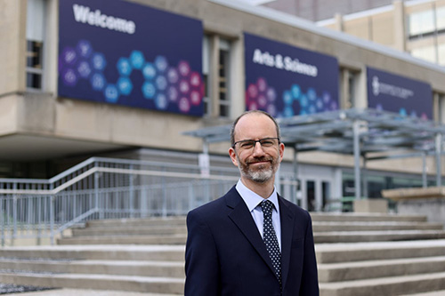 Stephen Wright in front of the Arts & Science Building