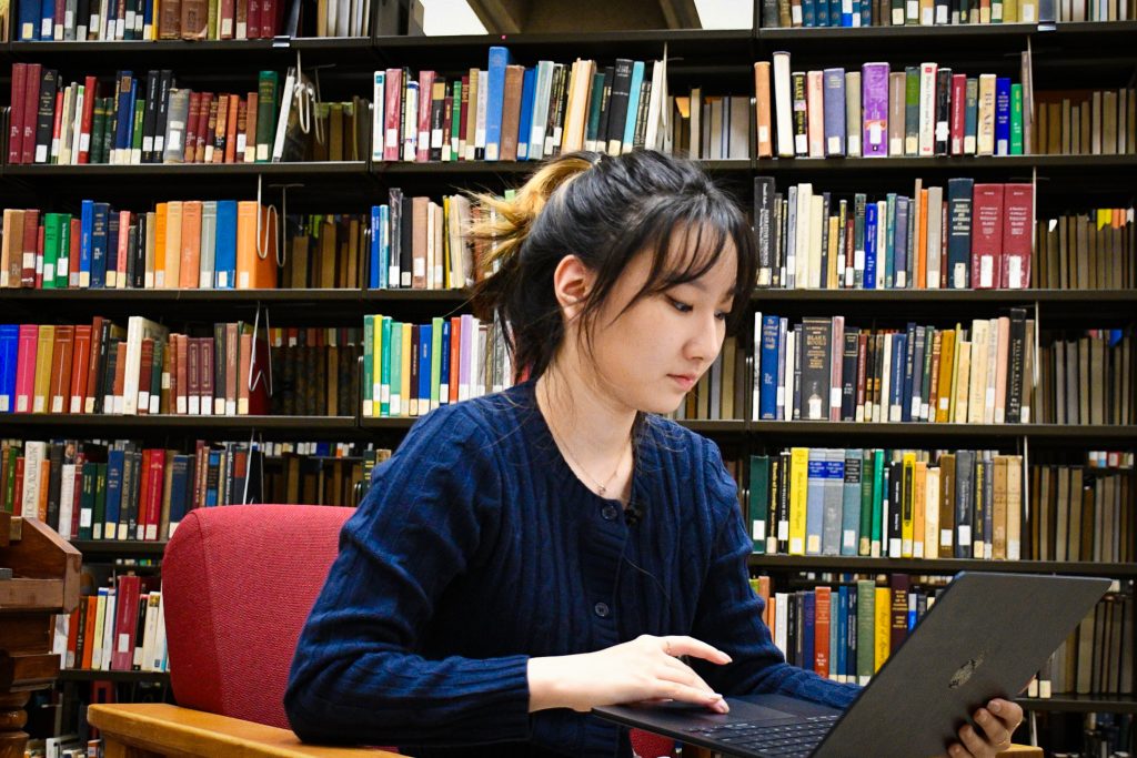 Student working on laptop in library
