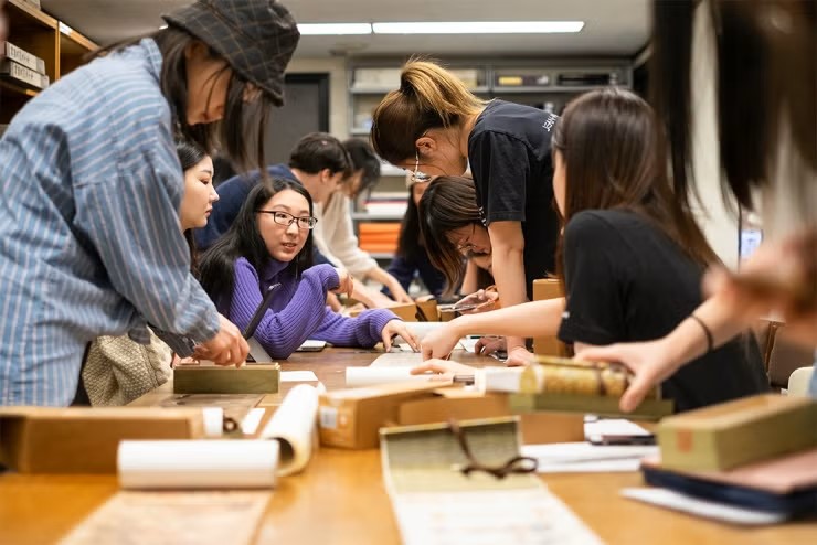 Students looking at old manuscripts - U of T