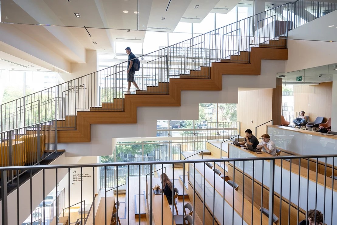 Person walking down staircase in U of T building