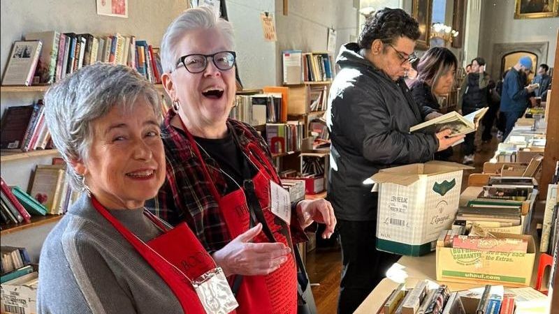 Volunteers and Shopers at the Book Sale in Seeley Hall among the shelves