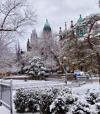 Snow covered front campus of Trinity College during winter