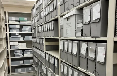 Stacks of archived material in a library shelf