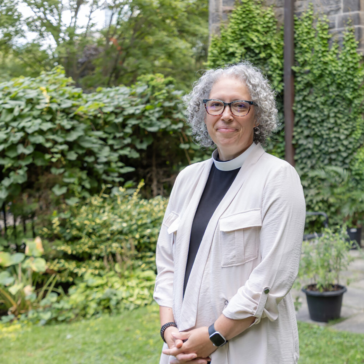 Paige Souter stands in a green garden