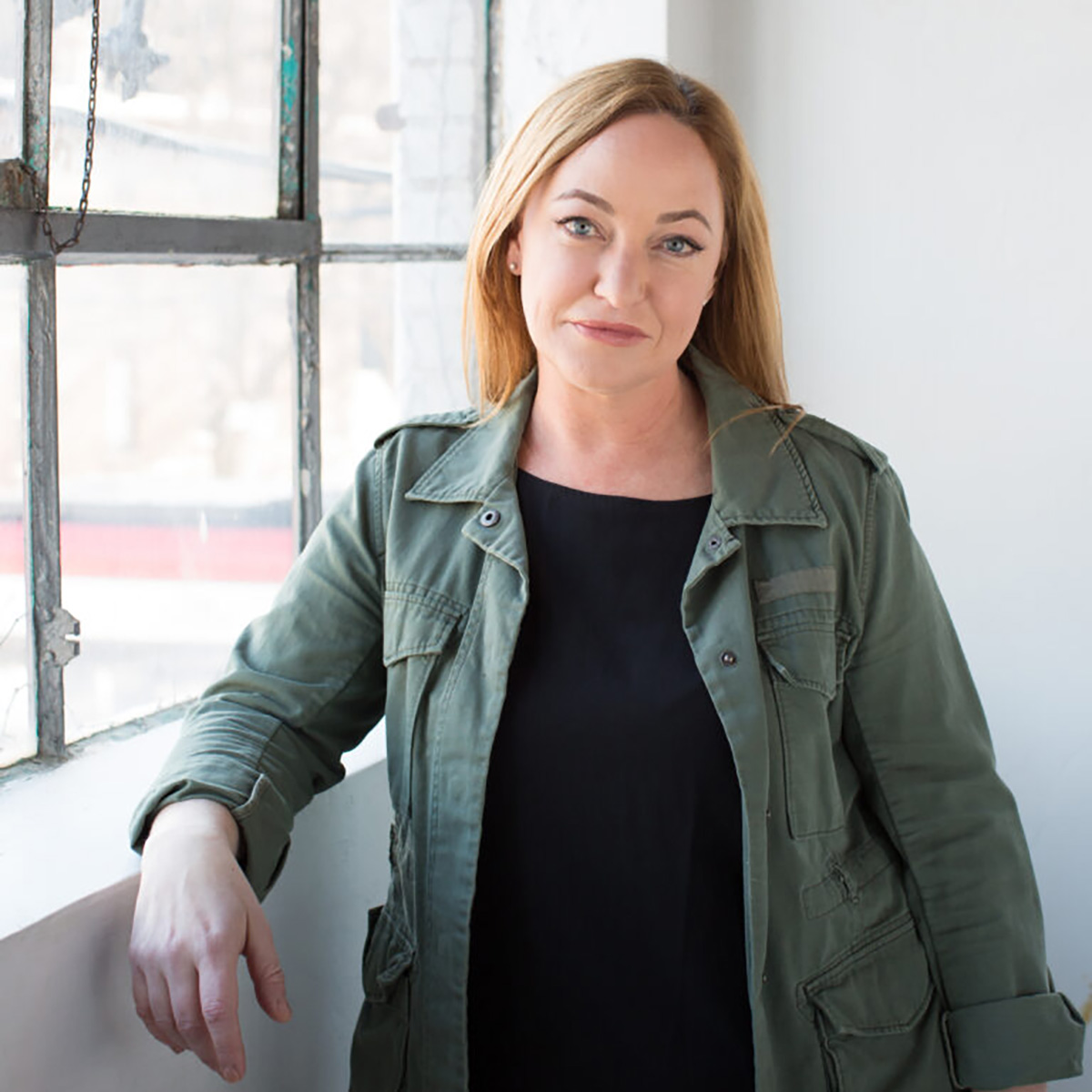 Tassie Cameron stands in front of a window