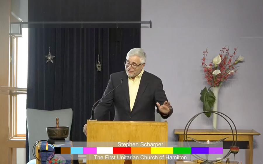 Stephen Scharper stands at lectern