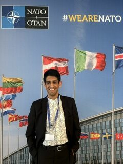 Zach Lidder stands inside NATO headquarters